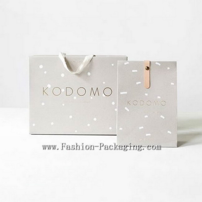 Modern packaging bag design for a stylish brand with Golden text and minimalist logo, geometric dots