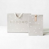 Modern packaging bag design for a stylish brand with Golden text and minimalist logo, geometric dots